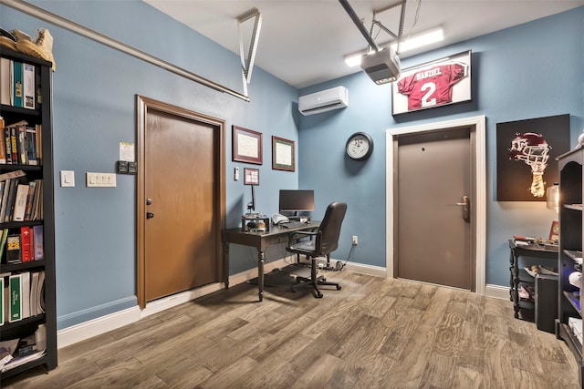 home office featuring hardwood / wood-style flooring and a wall unit AC