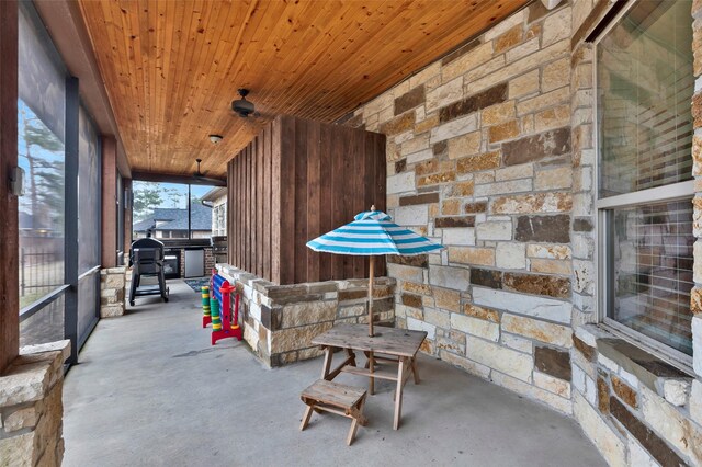 sunroom / solarium featuring wooden ceiling