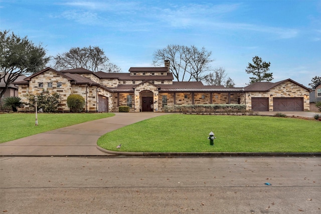 view of front of property with a garage and a front yard