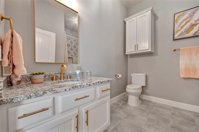 bathroom with vanity, toilet, and a shower