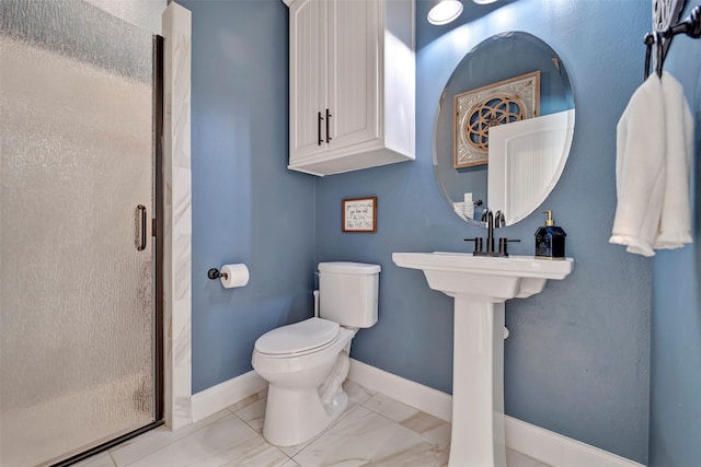 bathroom with a shower with shower door and toilet