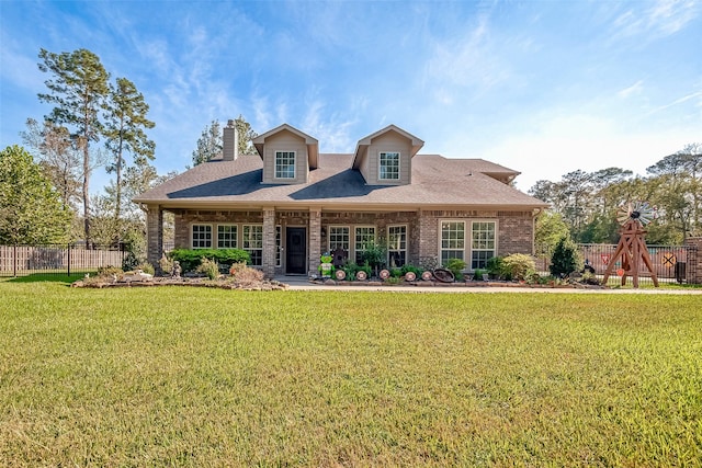 view of front of house with a playground and a front yard