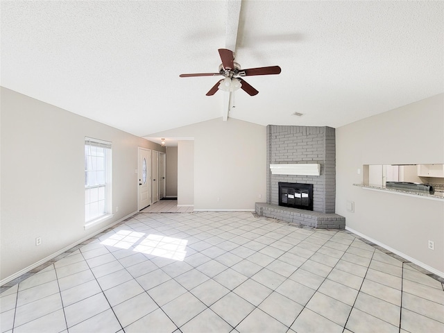 unfurnished living room with vaulted ceiling with beams, a fireplace, a textured ceiling, and ceiling fan