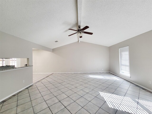 unfurnished living room featuring vaulted ceiling, light tile patterned flooring, ceiling fan, and plenty of natural light