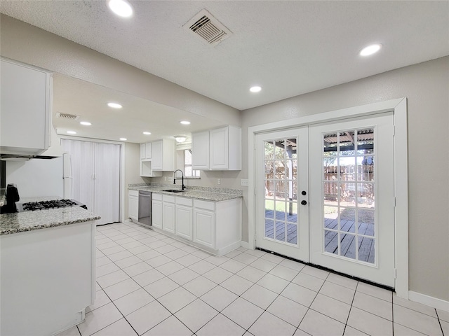 kitchen featuring sink, light stone countertops, white cabinets, stainless steel dishwasher, and french doors