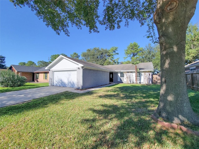 ranch-style home with a garage and a front lawn