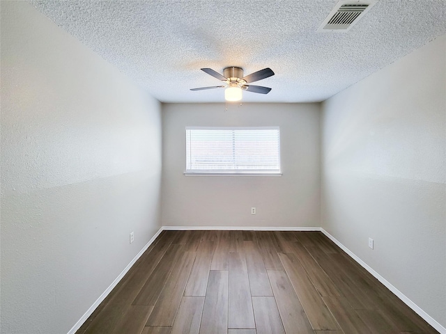 unfurnished room featuring ceiling fan, dark hardwood / wood-style flooring, and a textured ceiling