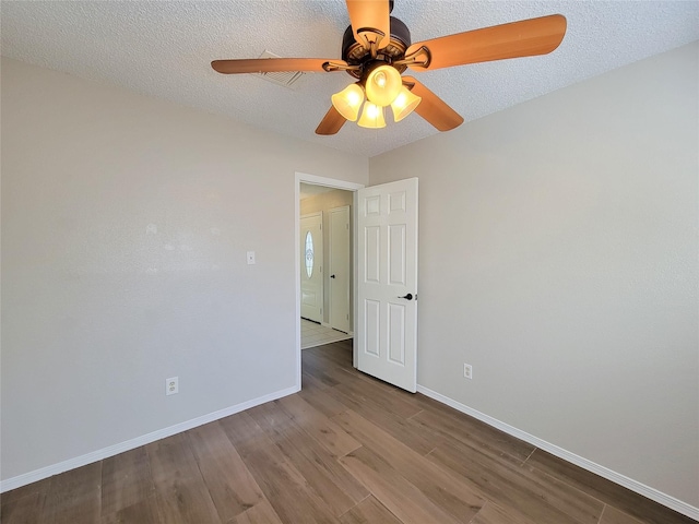 unfurnished room featuring ceiling fan, light hardwood / wood-style flooring, and a textured ceiling