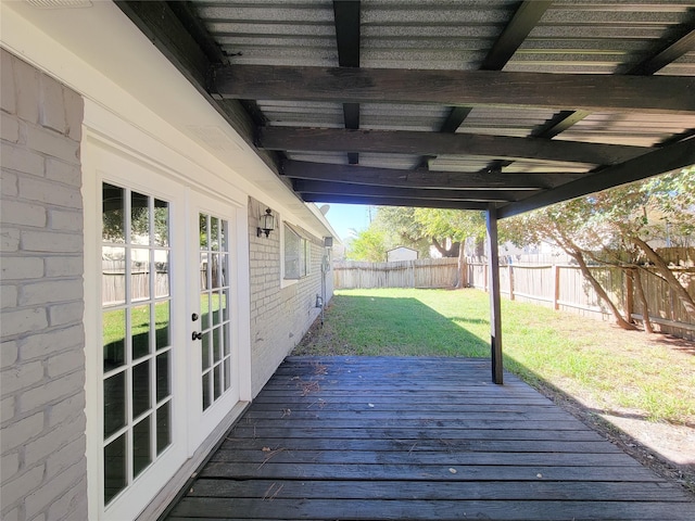 wooden deck featuring a yard and french doors