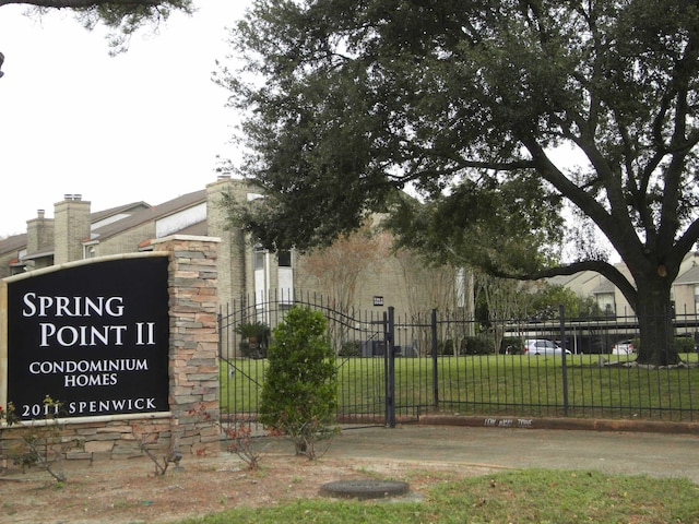 community / neighborhood sign with a yard