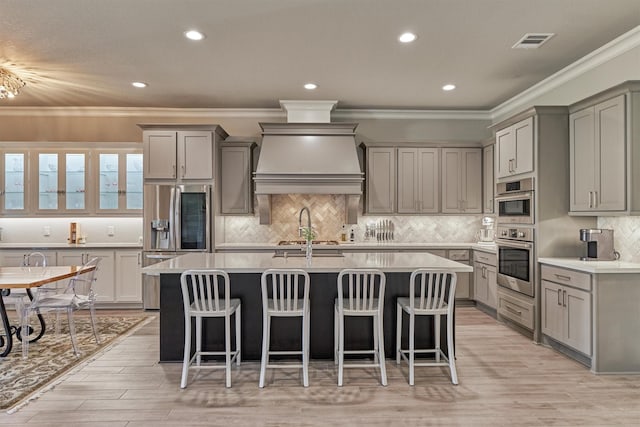 kitchen featuring stainless steel appliances, a breakfast bar area, and backsplash