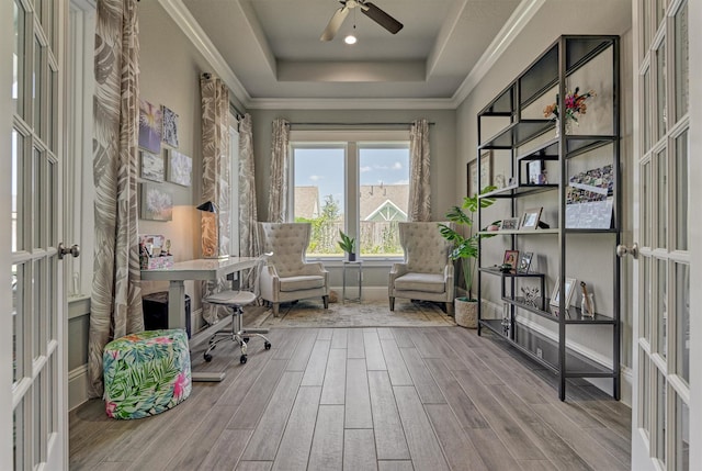 unfurnished office featuring french doors, ornamental molding, ceiling fan, and a tray ceiling