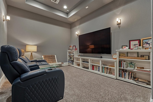 living room with carpet and a tray ceiling