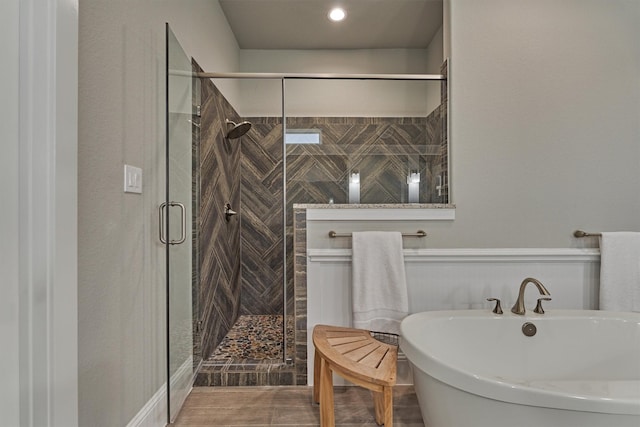 bathroom featuring shower with separate bathtub