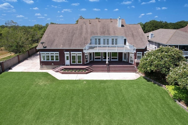 rear view of house featuring a patio area and a lawn