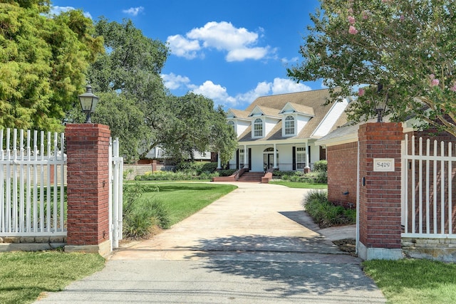 5419 W Bayshore Dr, Bacliff, TX 77518 - cape cod house featuring brick siding and covered porch