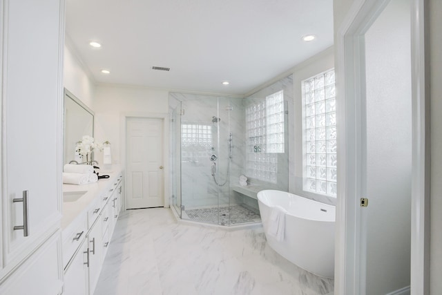 5419 W Bayshore Dr, Bacliff, TX 77518 - bathroom featuring a freestanding bath, healthy amount of natural light, a shower stall, double vanity, and recessed lighting