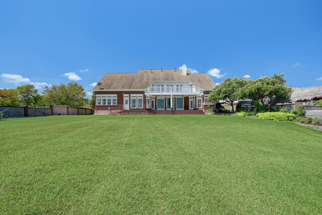5419 W Bayshore Dr, Bacliff, TX 77518 - back of house featuring a balcony and brick siding