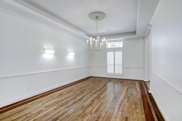 5419 W Bayshore Dr, Bacliff, TX 77518 - empty room featuring a chandelier, wood finished floors, crown molding, a tray ceiling, and baseboards