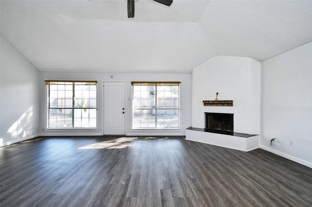 unfurnished living room featuring dark hardwood / wood-style flooring, vaulted ceiling, and ceiling fan