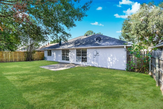 rear view of house with a patio area and a lawn