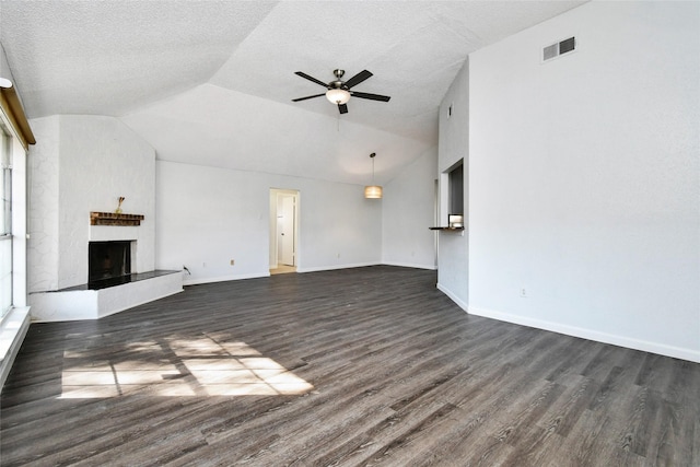 unfurnished living room featuring vaulted ceiling, dark wood-type flooring, ceiling fan, and a fireplace