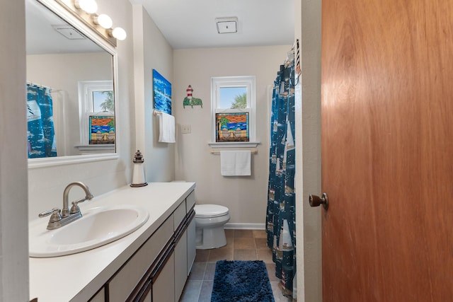 bathroom featuring vanity, tile patterned floors, and toilet