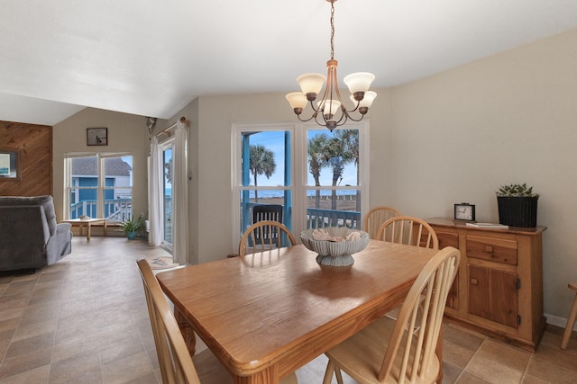 dining space featuring lofted ceiling and a chandelier