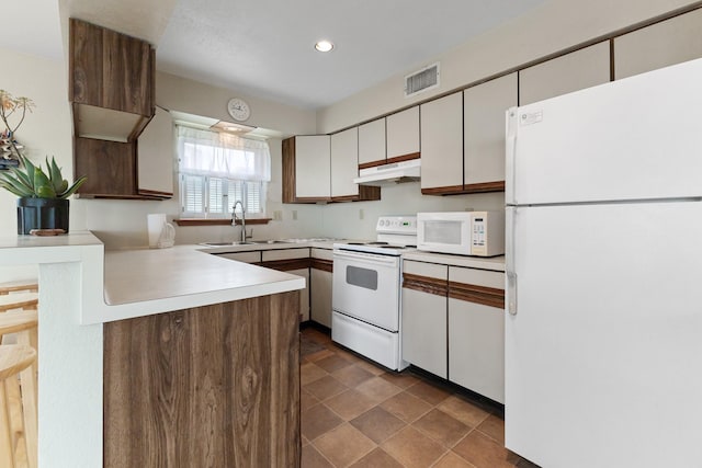 kitchen featuring white cabinetry, sink, and white appliances