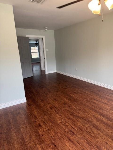 2748 Cos St, Liberty, TX 77575 - unfurnished room with baseboards, visible vents, dark wood-type flooring, and a ceiling fan