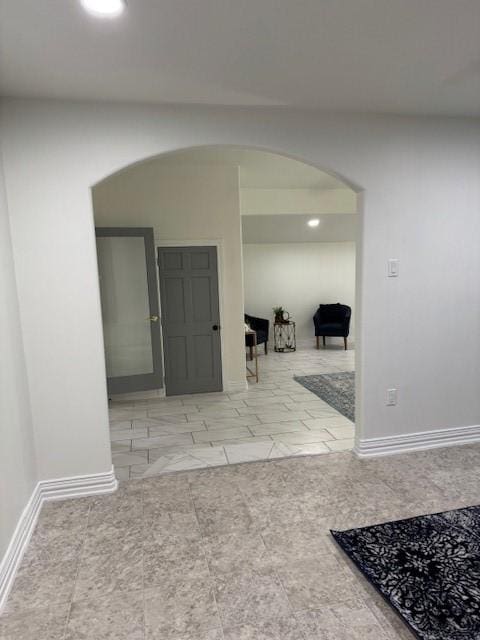 2748 Cos St, Liberty, TX 77575 - corridor featuring arched walkways, marble finish floor, and baseboards