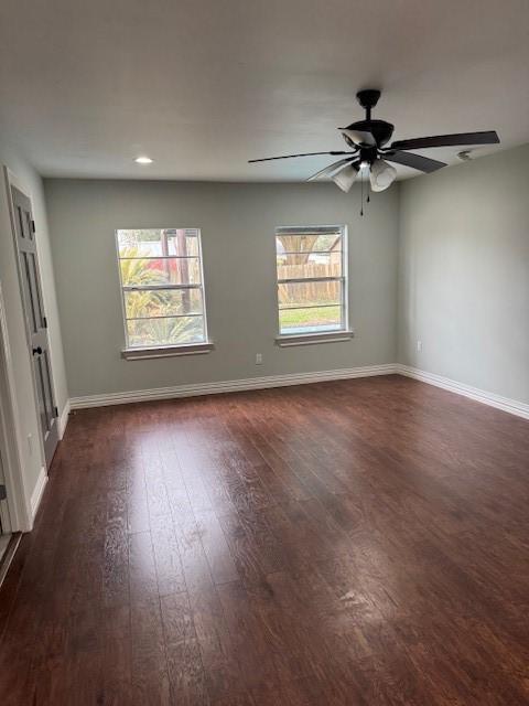 unfurnished room featuring ceiling fan and dark hardwood / wood-style floors