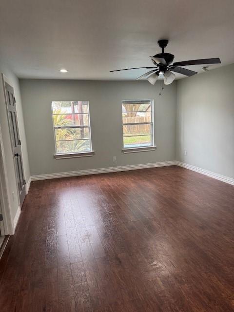 2748 Cos St, Liberty, TX 77575 - empty room with a ceiling fan, dark wood-type flooring, and baseboards