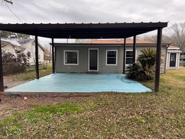 back of house with a yard and a patio