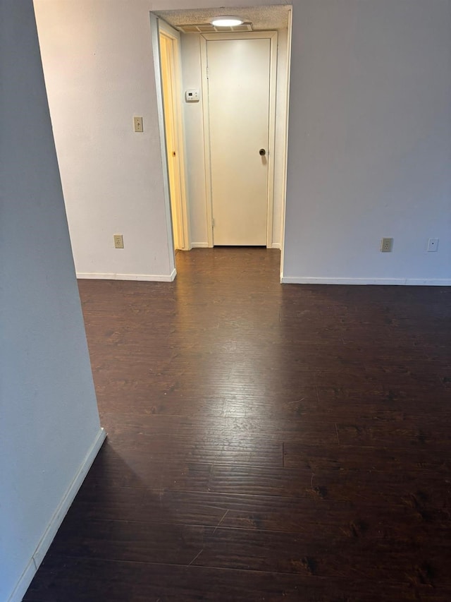 empty room featuring dark wood-type flooring