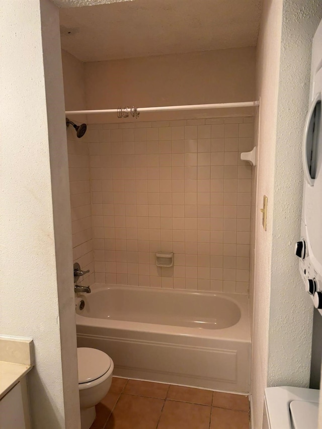 full bathroom featuring tiled shower / bath, tile patterned floors, toilet, and vanity