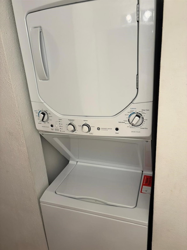 laundry area featuring stacked washer / dryer