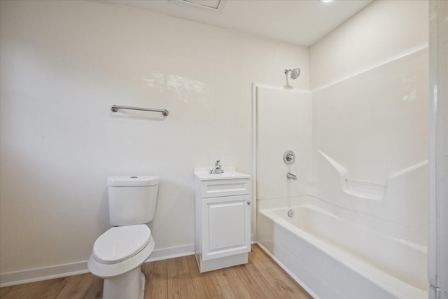 full bathroom with wood-type flooring, bathing tub / shower combination, vanity, and toilet