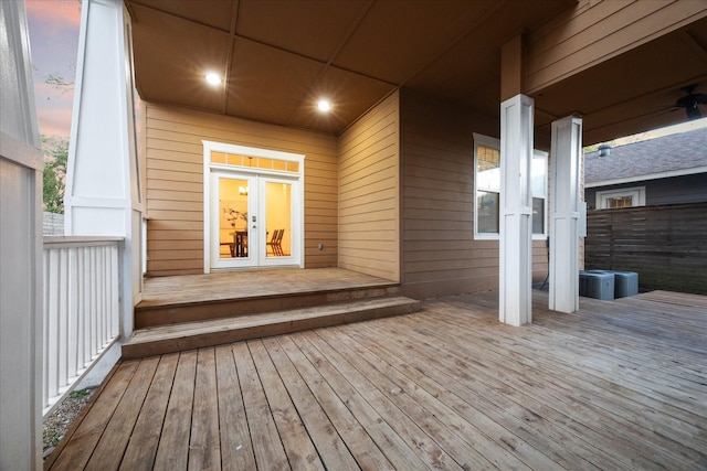 deck at dusk featuring french doors