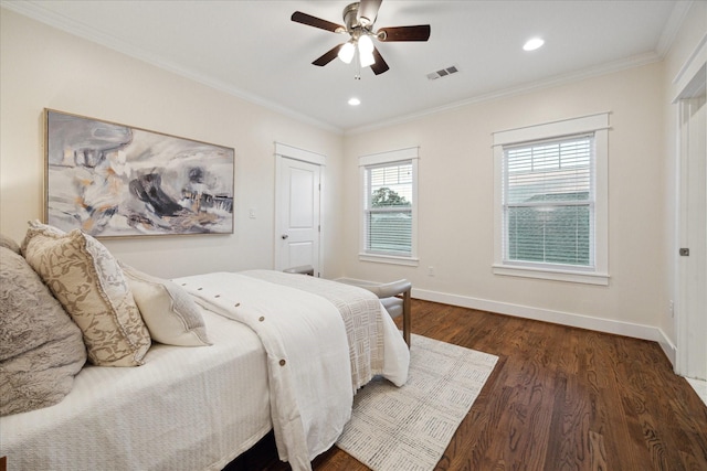 bedroom featuring dark wood-type flooring, ornamental molding, and ceiling fan