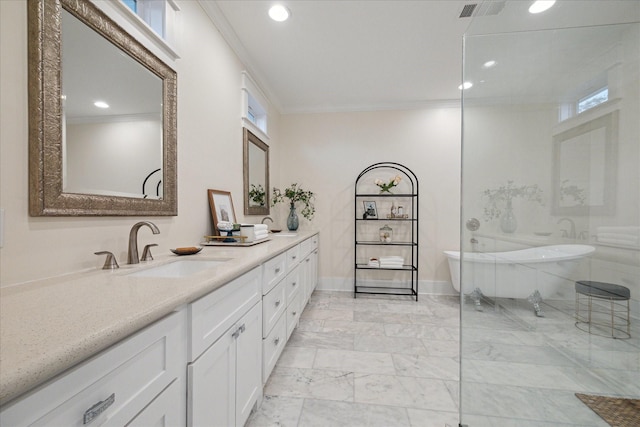 bathroom with crown molding, a tub to relax in, vanity, and plenty of natural light