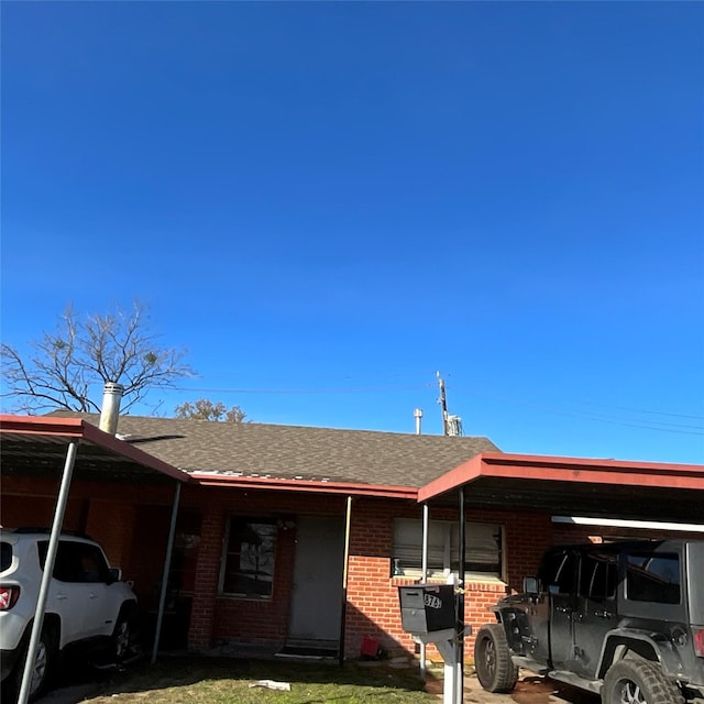 ranch-style house with a front yard and a carport