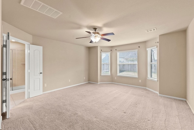 spare room with light colored carpet and ceiling fan