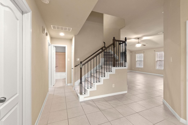 interior space with tile patterned floors and ceiling fan