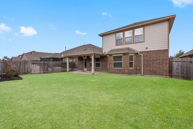 rear view of property featuring a patio and a lawn