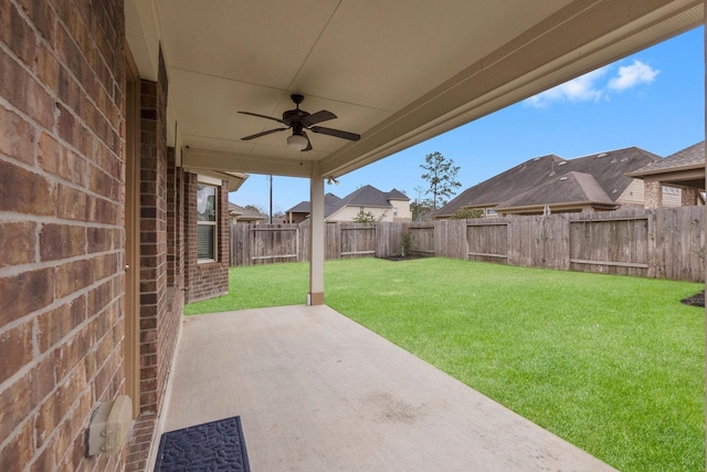 view of yard featuring ceiling fan and a patio area