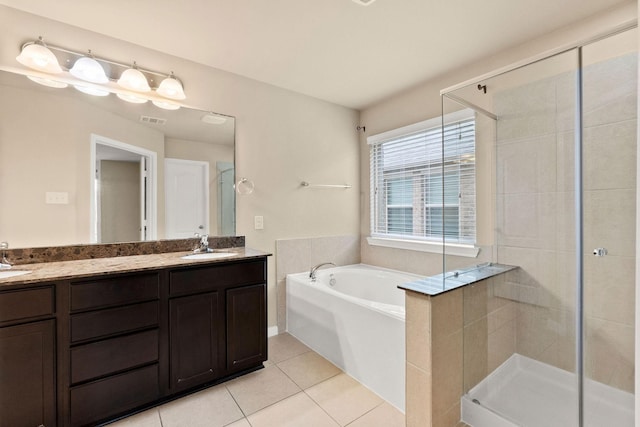 bathroom featuring tile patterned flooring, vanity, and separate shower and tub