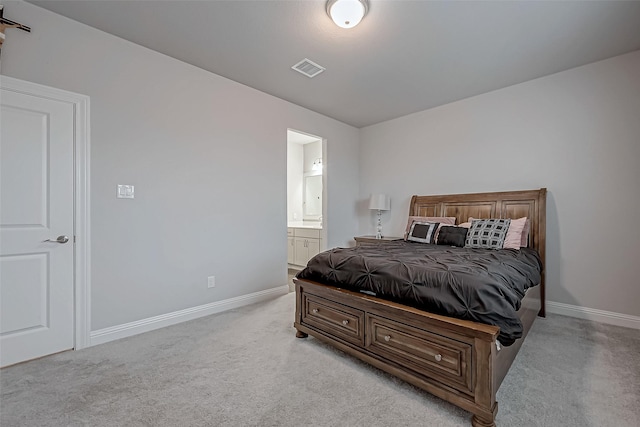 carpeted bedroom with ensuite bath