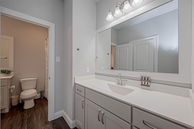 bathroom with vanity, hardwood / wood-style floors, and toilet