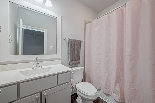 full bathroom featuring vanity, toilet, and shower / bath combo with shower curtain